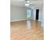 Open-concept living room with wood floors, a window, and modern ceiling fan fixture at 1515 Bayshore Blvd # 38, Dunedin, FL 34698