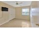 Cozy bedroom featuring neutral walls and a window, complemented by a ceiling fan at 1604 Comfy Ct, Sun City Center, FL 33573