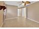 Spacious bedroom with neutral walls, tile flooring, and open doorway at 1604 Comfy Ct, Sun City Center, FL 33573