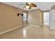 Simple bedroom with tile flooring, ceiling fan, and neutral wall color at 1604 Comfy Ct, Sun City Center, FL 33573