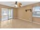 Neutral bedroom with tile floor, ceiling fan, and sliding glass doors to sunroom at 1604 Comfy Ct, Sun City Center, FL 33573