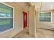 Covered front porch with columns, decorative trim, and a vibrant red front door at 1604 Comfy Ct, Sun City Center, FL 33573
