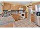 Updated kitchen featuring granite countertops, stainless steel appliances, and tile backsplash at 1604 Comfy Ct, Sun City Center, FL 33573