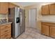Well-equipped kitchen with stainless steel refrigerator and ample cabinet space for storage at 1604 Comfy Ct, Sun City Center, FL 33573