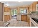 Functional kitchen with wood cabinets, granite countertops, and stainless steel sink at 1604 Comfy Ct, Sun City Center, FL 33573