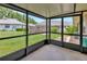 View of the well-maintained lawn from the screened-in lanai, creating a seamless indoor-outdoor living experience at 1604 Comfy Ct, Sun City Center, FL 33573