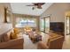 Bright and airy living room with vaulted ceiling, ceiling fan, and large sliding glass door at 1604 Comfy Ct, Sun City Center, FL 33573