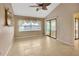 Bright living room with tile flooring, ceiling fan and sliding glass door at 1604 Comfy Ct, Sun City Center, FL 33573