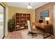 Well-lit office space with modern desk, shelving, and a comfortable chair, perfect for productivity at 1604 Comfy Ct, Sun City Center, FL 33573
