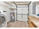 Functional utility room with washer, water heater, work bench, and tile flooring at 1604 Comfy Ct, Sun City Center, FL 33573
