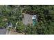 Aerial view of a home with a private pool surrounded by lush greenery and mature trees at 1613 Long Pond Dr, Valrico, FL 33594