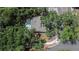 Aerial view of a home with a pool, surrounded by mature trees and lush landscaping at 1613 Long Pond Dr, Valrico, FL 33594