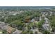 Aerial view of a home surrounded by mature trees and lush landscaping in a quiet residential neighborhood at 1613 Long Pond Dr, Valrico, FL 33594