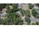 Aerial view of a home surrounded by mature trees and lush landscaping in a quiet residential neighborhood at 1613 Long Pond Dr, Valrico, FL 33594