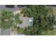 Aerial view of a home with a pool, surrounded by mature trees and lush landscaping at 1613 Long Pond Dr, Valrico, FL 33594