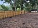 Wood-fenced backyard providing privacy, accented by a storage shed at 1613 Long Pond Dr, Valrico, FL 33594