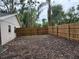 Large fenced back yard with mature trees and space for gardening or outdoor activities at 1613 Long Pond Dr, Valrico, FL 33594