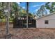 Backyard view of screened-in pool enclosure attached to the home on a spacious lot at 1613 Long Pond Dr, Valrico, FL 33594