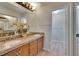Bathroom featuring double vanity, granite countertop, and wood cabinets at 1613 Long Pond Dr, Valrico, FL 33594