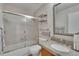 Cozy bathroom featuring a shower-tub combo with glass doors and a granite vanity top at 1613 Long Pond Dr, Valrico, FL 33594