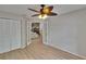 Bedroom with closet and French doors, featuring light-colored wood-look flooring at 1613 Long Pond Dr, Valrico, FL 33594