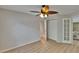 Spacious bedroom with closet, ceiling fan, and doorway, featuring light-colored wood-look flooring at 1613 Long Pond Dr, Valrico, FL 33594
