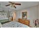 A main bedroom with wood furnishings and a window with blinds at 1613 Long Pond Dr, Valrico, FL 33594