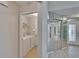 Hallway with mirrored closet and laundry room featuring a modern washer and dryer at 1613 Long Pond Dr, Valrico, FL 33594