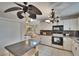 Bright kitchen boasts white cabinets, granite countertops, tile flooring, and stainless steel appliances at 1613 Long Pond Dr, Valrico, FL 33594