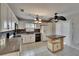 Spacious kitchen features white cabinets, granite counters, tile flooring, and a center island at 1613 Long Pond Dr, Valrico, FL 33594