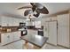 Open kitchen with white cabinets, granite counters, and tile flooring with an island at 1613 Long Pond Dr, Valrico, FL 33594