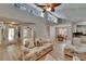Open concept living room with wood floors, ceiling fan, and high ceilings at 1613 Long Pond Dr, Valrico, FL 33594