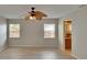 Bright living room with wood floors, ceiling fan, and natural light from two windows at 1613 Long Pond Dr, Valrico, FL 33594