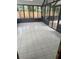 An airy sunroom featuring durable tile flooring and a clear view of the outdoor swimming pool at 1613 Long Pond Dr, Valrico, FL 33594
