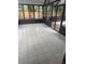 Well lit sunroom features durable tile flooring with a view of the outside pool area at 1613 Long Pond Dr, Valrico, FL 33594