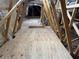 Bright attic featuring plywood flooring and wooden beams at 17566 Hyland Ln, Dade City, FL 33523