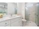 Modern bathroom features a bright vanity with ample storage and a glass-enclosed walk-in shower at 17566 Hyland Ln, Dade City, FL 33523