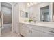 Clean bathroom with a sleek vanity, white countertops, modern fixtures, and a view of the shower at 17566 Hyland Ln, Dade City, FL 33523