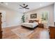Bright, spacious bedroom with wood floors, a ceiling fan, and natural lighting at 17566 Hyland Ln, Dade City, FL 33523