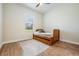 Cozy bedroom with hardwood floors, a day bed, and a large window overlooking the exterior at 17566 Hyland Ln, Dade City, FL 33523