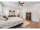 Large bedroom with wood floors, a ceiling fan, and two dressers at 17566 Hyland Ln, Dade City, FL 33523