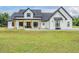 Stunning modern farmhouse with white siding, black trim, and inviting front porch at 17566 Hyland Ln, Dade City, FL 33523