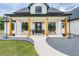 Inviting front porch with rocking chairs and wood columns, perfect for relaxing at 17566 Hyland Ln, Dade City, FL 33523