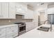 Modern eat-in kitchen shows a long island with seating, stainless appliances and ample countertop space at 17566 Hyland Ln, Dade City, FL 33523