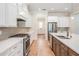 Bright eat-in kitchen boasts an expansive island, stainless appliances and lots of countertop space at 17566 Hyland Ln, Dade City, FL 33523