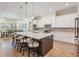 Modern eat-in kitchen island seating and lighting, stainless appliances and view of dining area at 17566 Hyland Ln, Dade City, FL 33523