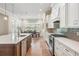 Modern eat-in kitchen features a long island, modern appliances and is open to the dining and entertaining spaces at 17566 Hyland Ln, Dade City, FL 33523