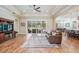 Open-concept living room with hardwood floors and ample natural light at 17566 Hyland Ln, Dade City, FL 33523