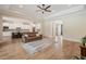 Open-concept living room showcases an eat-in kitchen, a large rug and lots of natural light throughout the space at 17566 Hyland Ln, Dade City, FL 33523