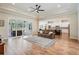 Open concept living room flowing into kitchen with large sliding doors to outside patio at 17566 Hyland Ln, Dade City, FL 33523